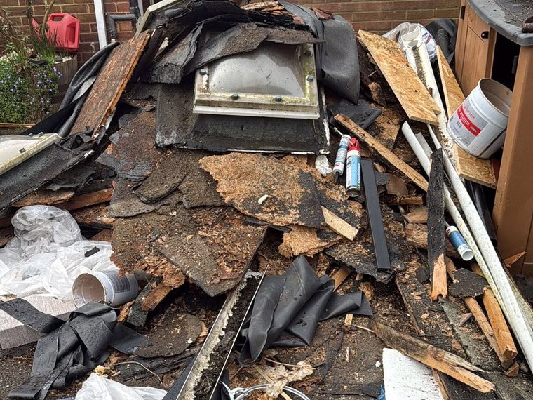 Pile of building waste on a driveway before removal