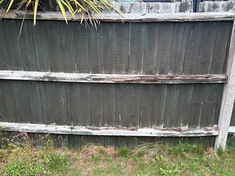 Old damaged fence panel before replacement