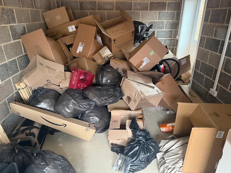 Garage full of boxes and bin bags before clearance